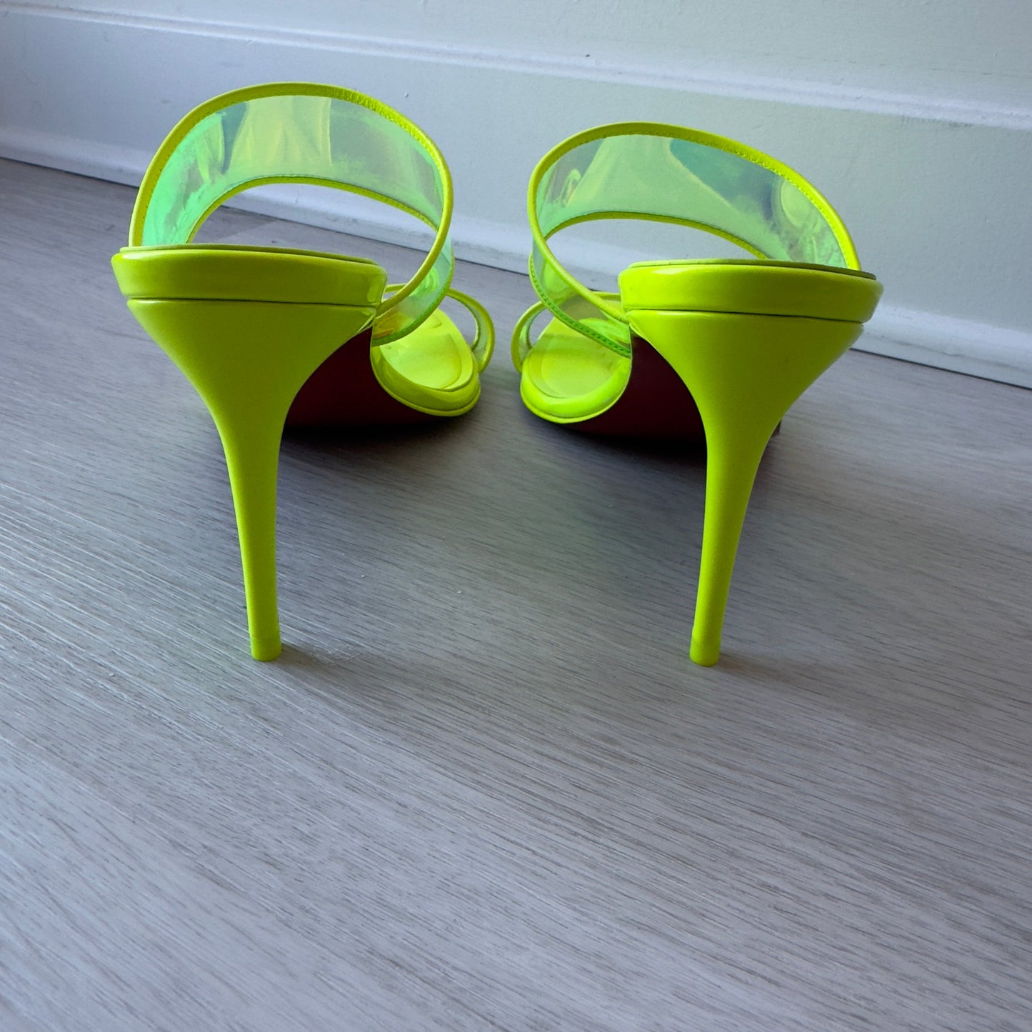 Stush Fashionista Christian Louboutin Just Loubi 85 neon green leather and PVC high heel sandals, back view.